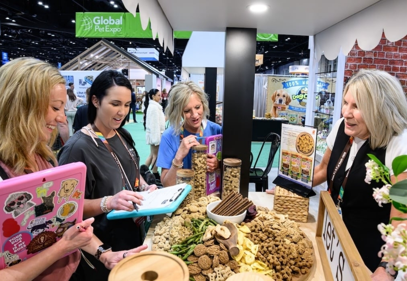 Global Pet Expo trade show booth area with attendees interacting and branded signage inside convention center