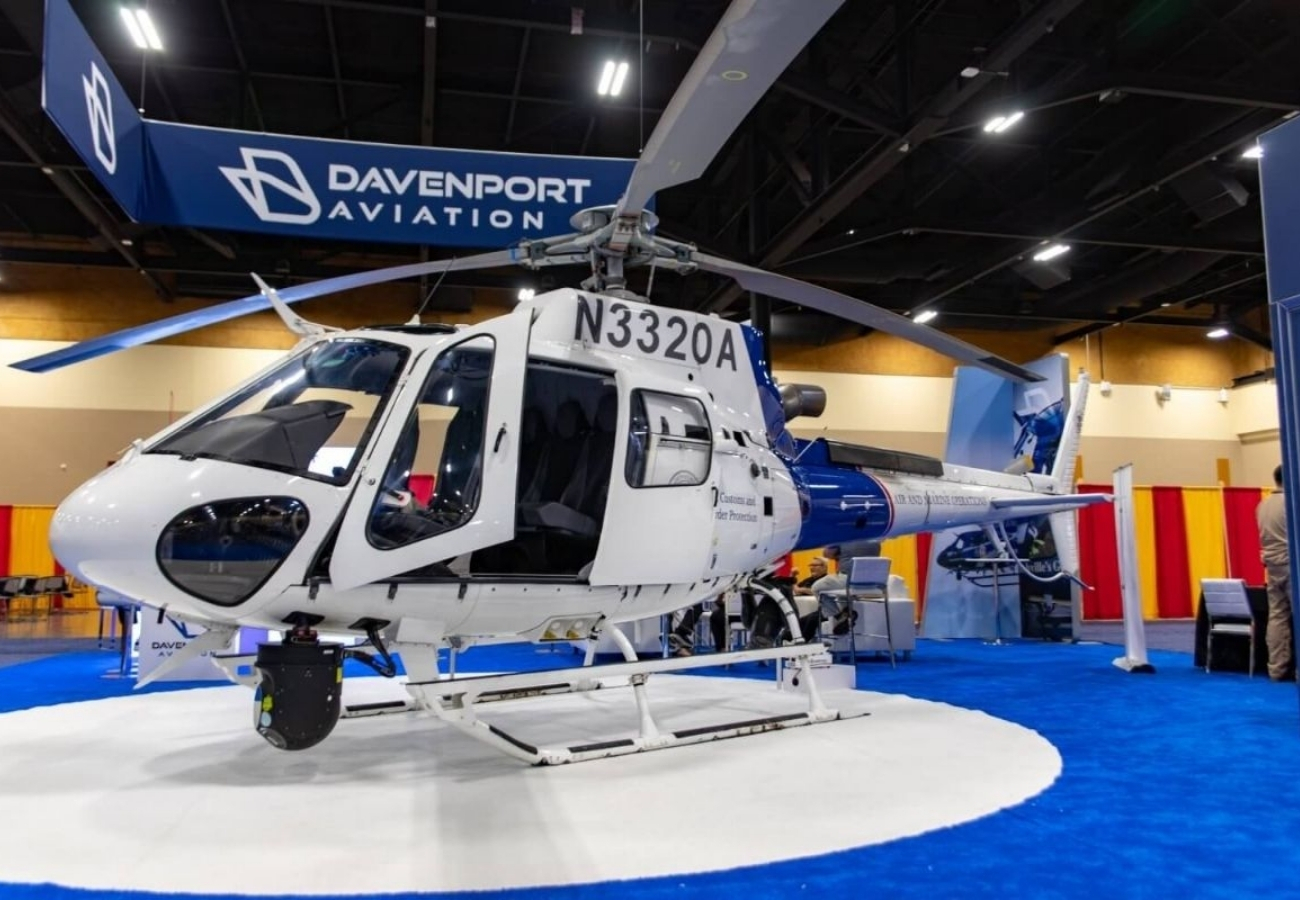 Helicopter display at trade show booth with Davenport Aviation branding inside convention center exhibit space